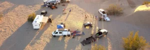 Aerial View of Desert Safari Camp with Vehicles and Tourists in Abu Dhabi