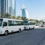 White minibuses for centralized desert safari pickup in Abu Dhabi