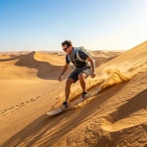 Traveler sandboarding on golden dunes during a Morning Desert Safari in Abu Dhabi