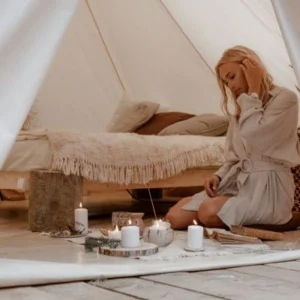 Guest relaxing inside a luxury desert tent during an Overnight Desert Safari Abu Dhabi.