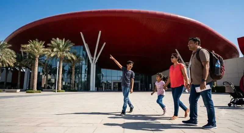 Family arriving at the Yas Island theme park entrance during an Abu Dhabi city tour with Ferrari World