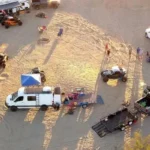 Aerial View of Desert Safari Camp with Vehicles and Tourists in Abu Dhabi