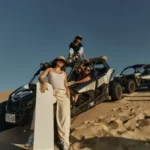 Visitors posing with a dune buggy during an Evening Desert Safari Abu Dhabi adventure.