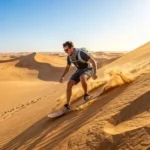 Traveler sandboarding on golden dunes during a Morning Desert Safari in Abu Dhabi