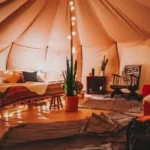 Luxury desert tent interior with comfortable bedding during an Overnight Desert Safari Abu Dhabi.